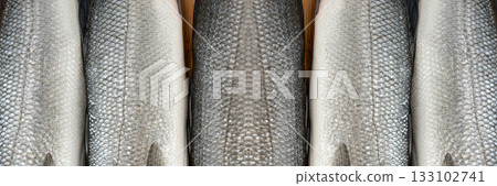 Fish scales texture background, sea bass skin close up, macro shot of silver labrax scale 133102741