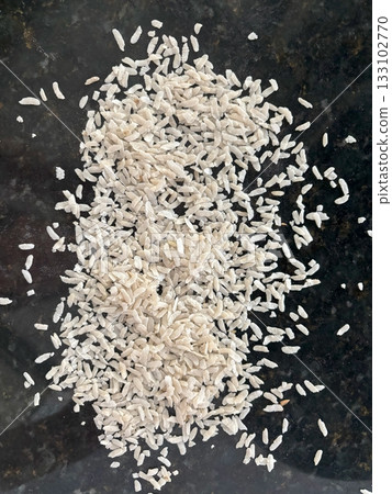 Raw flattened rice close up. Dry rice flakes or poha, Indian breakfast food 133102770