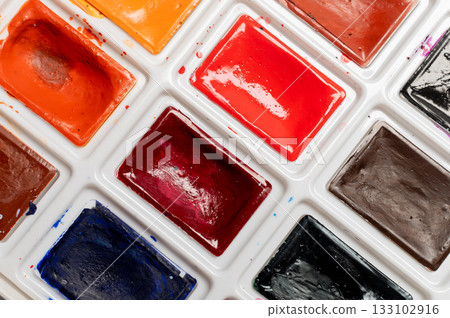 macro watercolor palette featuring wet, vibrant colors in red and green hues. Creative aesthetic idea, background macro watercolor palette featuring wet, vibrant colors in red and green hues. Creative aesthetic idea, background 133102916