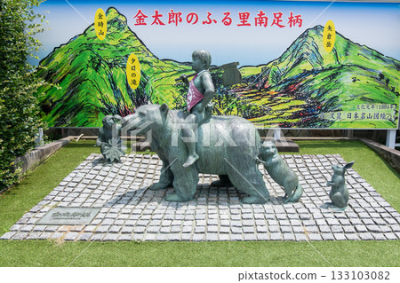 Daiyuzan station, Minamiashigara, Kanagawa, Japan - July 20, 2025 : Statue of boy riding bear with raccoon and rabbit in outdoor park with mural Daiyuzan station, Minamiashigara, Kanagawa, Japan - July 20, 2025 : Statue of boy riding bear with raccoon and rabbit in outdoor park with mural 133103082