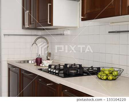 Home chef organizing tools in compact kitchen environment 133104220