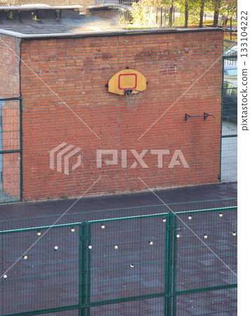 Outdoor Basketball Court with Brick Wall 133104222