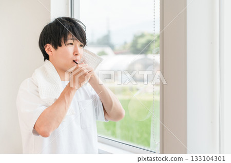 Young Asian man brushing his teeth in the morning (dental care, toothbrush, whitening, oral care) 133104301