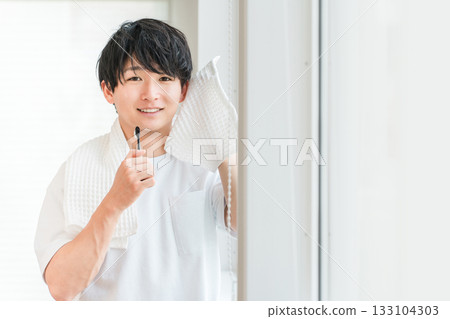Young Asian man brushing his teeth in the morning (dental care, toothbrush, whitening, oral care) 133104303