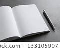 Notebook and ballpoint pen on a gray background Notebook and ballpoint pen on a gray background 133105907