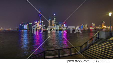 Shanghai skyline at night with colorful reflections over the Huangpu River Shanghai skyline at night with colorful reflections over the Huangpu River 133106599