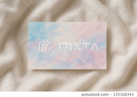 Pastel watercolor card on soft fabric background. Delicate mockup with blue, pink, and purple texture for branding, message, or invitation. 133108343