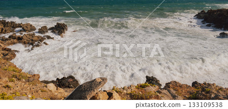 Mediterranean seascape during windy but sunny weather with waves breaking on the shore. 133109538