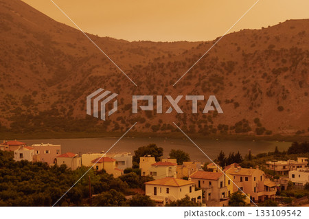 Dramatic sahara dust storm over crete, turning the sky an intense, apocalyptic orange color Dramatic sahara dust storm over crete, turning the sky an intense, apocalyptic orange color 133109542