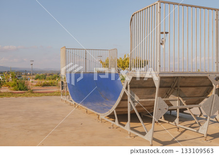Empty concrete skate park ramp for skateboarding and rollerblading action sports 133109563