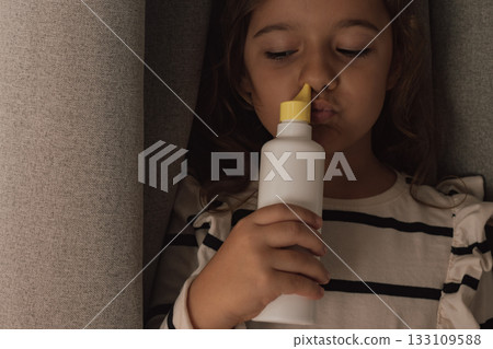 Applying unbranded saline nasal spray for respiratory hygiene and allergy relief Applying unbranded saline nasal spray for respiratory hygiene and allergy relief 133109588