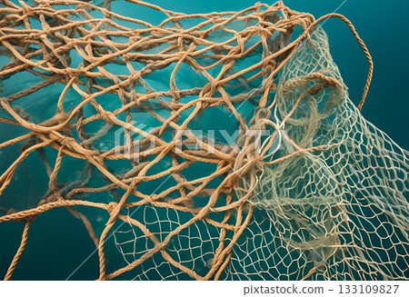 Tangled fishing nets underwater against a blue ocean background.AI Generated Tangled fishing nets underwater against a blue ocean background.AI Generated 133109827