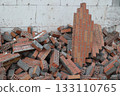 Pile of Bricks and Rubble Against White Wall 133110765