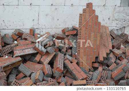 Pile of Bricks and Rubble Against White Wall Pile of Bricks and Rubble Against White Wall 133110765