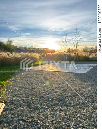 Golden Hour Sunset over Grassy Field and Path Golden Hour Sunset over Grassy Field and Path 133110795