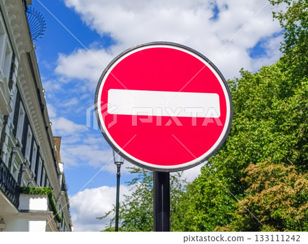 Do Not Enter road sign on urban street, red prohibition symbol 133111242