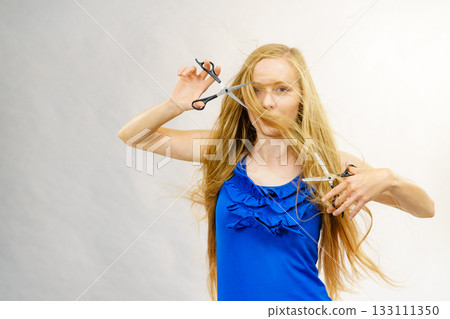 Girl with scissors for haircutting Girl with scissors for haircutting 133111350