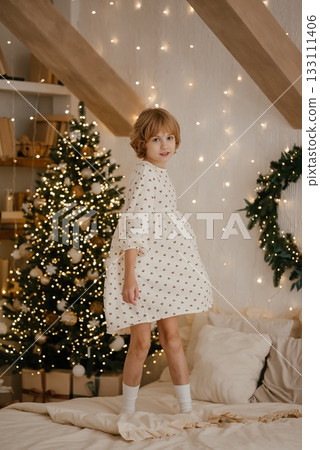 Joyful Child Enjoys Christmas in Festive Living Room 133111406