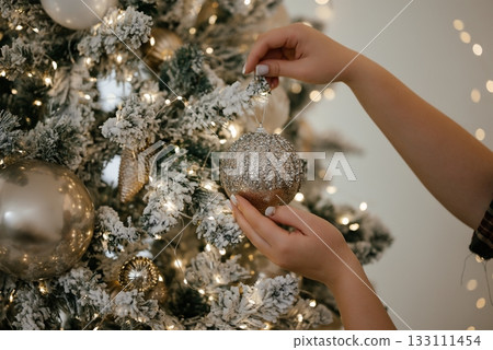 Decorating Christmas Tree with Sparkling Ornament Decorating Christmas Tree with Sparkling Ornament 133111454