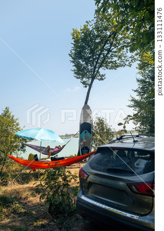 Relaxing in a Hammock by the Lake 133111476