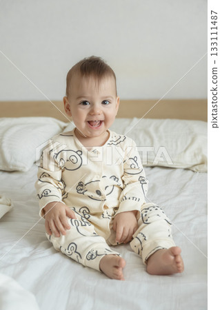 Joyful baby in bear print pajamas 133111487