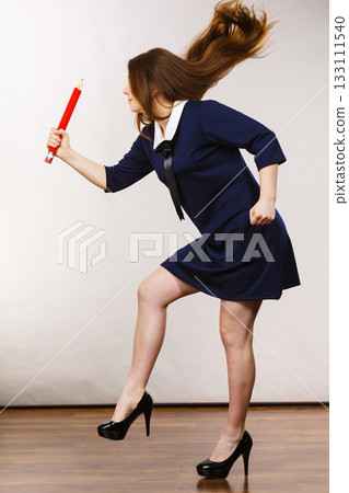Student woman holding big pencil Student woman holding big pencil 133111540