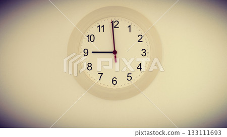 clock on wall showing nine hours 133111693