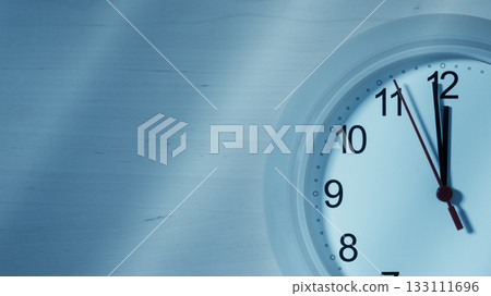 Clock ticking showing twelve hours 133111696