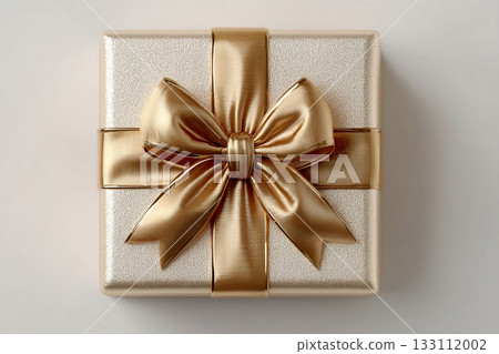 Luxury present. Gold box wrapped with a bow on white background. Jewelry, birthdays, Christmas and luxury branding. 133112002