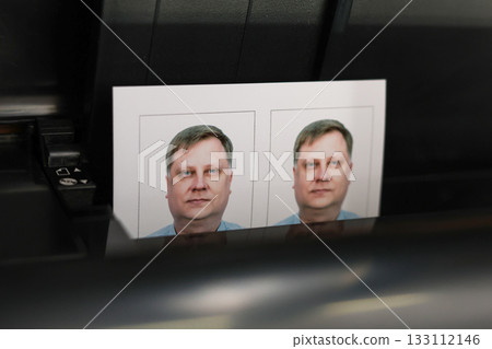 Printing documents on a printer. Photo studio service - creating photos for passports, passes, and ID cards Printing documents on a printer. Photo studio service - creating photos for passports, passes, and ID cards 133112146