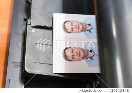 Printing documents on a printer. Photo studio service - creating photos for passports, passes, and ID cards Printing documents on a printer. Photo studio service - creating photos for passports, passes, and ID cards 133112148