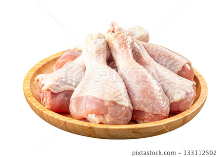 Isolated raw chicken drumsticks on plate Isolated raw chicken drumsticks on plate 133112502