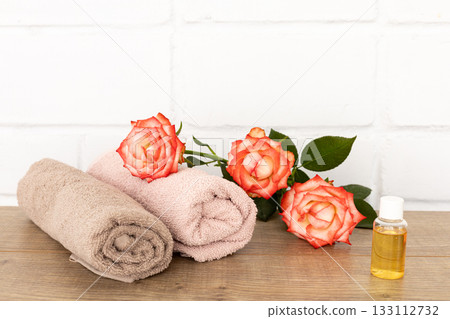 Spa composition with towels, aroma oil and flowers. 133112732