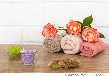 Spa composition with towels, flowers, sea salt and soap on the wooden boards. 133112736