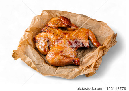 Isolated roasted chicken on parchment sheet Isolated roasted chicken on parchment sheet 133112778