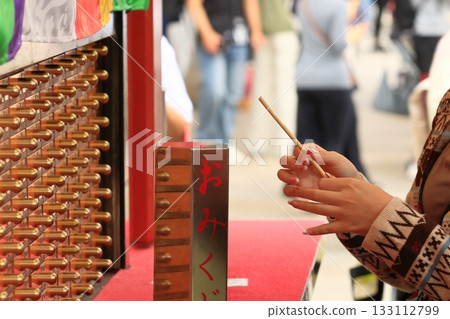 Tourists drawing fortune slips at Sensoji Temple Tourists drawing fortune slips at Sensoji Temple 133112799