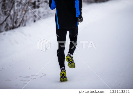 Rear view runner man legs running winter park 133113231