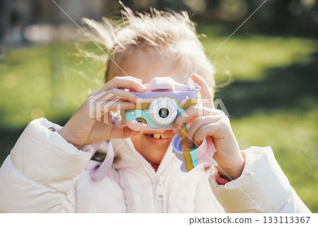 Child Taking Photos with Toy Camera in Playground Child Taking Photos with Toy Camera in Playground 133113367
