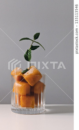 Orange Ice Cubes with Mint in Glass Orange Ice Cubes with Mint in Glass 133113546