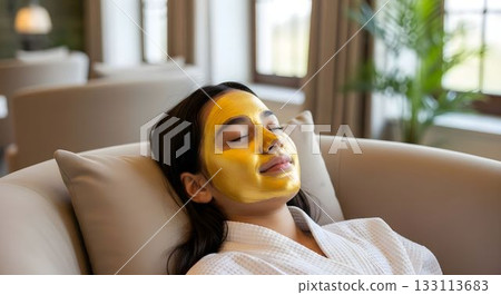 Relaxing spa treatment with a woman enjoying a gold facial in a serene setting Relaxing spa treatment with a woman enjoying a gold facial in a serene setting 133113683