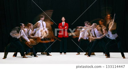 Leader in red jacket facing two opposing groups moving toward each other with motion blur Leader in red jacket facing two opposing groups moving toward each other with motion blur 133114447