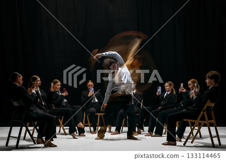 Performer blurred motion surrounded by individuals recording with smartphones symbolizing digital attention culture Performer blurred motion surrounded by individuals recording with smartphones symbolizing digital attention culture 133114465