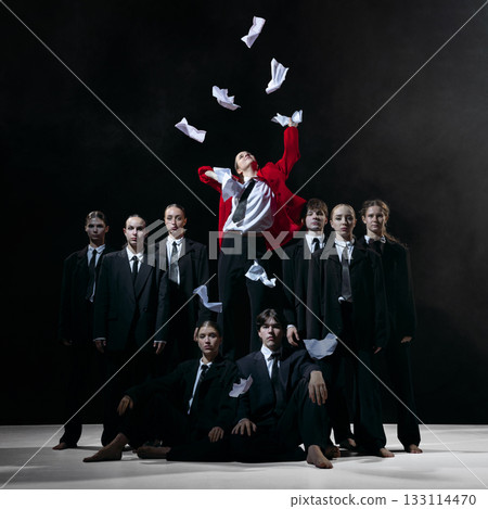 Leader in red coat throwing papers as metaphor for burnout, resignation and HR communication themes Leader in red coat throwing papers as metaphor for burnout, resignation and HR communication themes 133114470