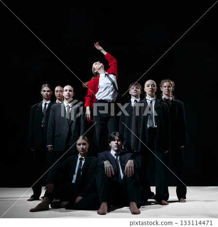 Leader in red coat standing above team symbolizing visionary direction and disruptive startup energy Leader in red coat standing above team symbolizing visionary direction and disruptive startup energy 133114471