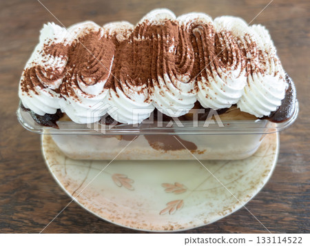 Banoffee Cake with Whipped Cream and Cocoa Powder. Banoffee Cake with Whipped Cream and Cocoa Powder. 133114522