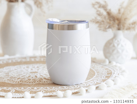 White stainless steel 12oz tumbler on boho placemat near pampas grass Closeup, mockup White stainless steel 12oz tumbler on boho placemat near pampas grass Closeup, mockup 133114935