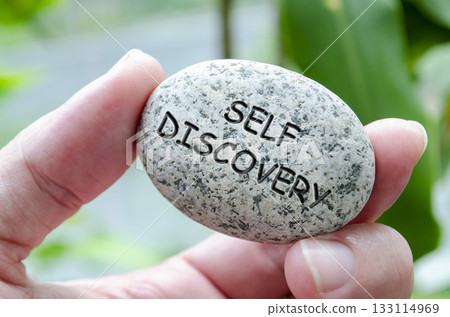 Self Discovery text engraved on dark stone. Life harmony concept Self Discovery text engraved on dark stone. Life harmony concept 133114969