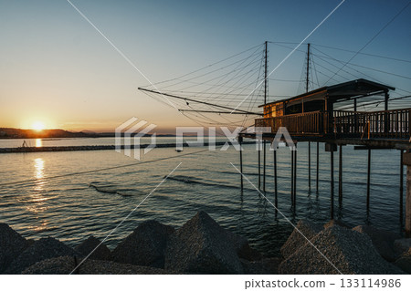 Trabocco structure at sunset in Pescara seascape, Italy. 133114986