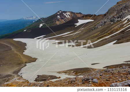 View of snow-capped Mount Biei and its crater topography from the Tokachidake hiking trail in Hokkaido's 100 famous mountains 133115316