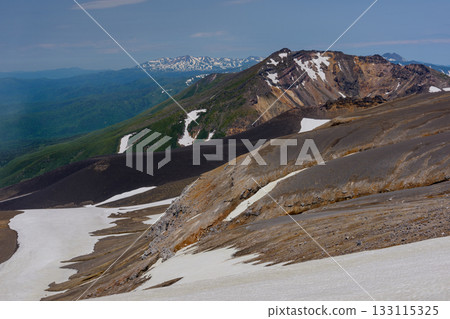 View of snow-capped Mount Biei and its crater topography from the Tokachidake hiking trail in Hokkaido's 100 famous mountains View of snow-capped Mount Biei and its crater topography from the Tokachidake hiking trail in Hokkaido's 100 famous mountains 133115325